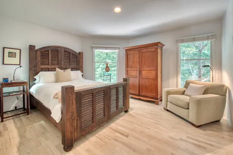 a bedroom with a large bed and a couch