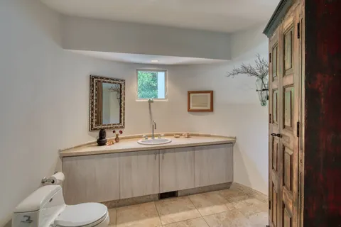 a bathroom with a sink toilet and mirror