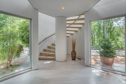 a view of entryway with furniture and garden