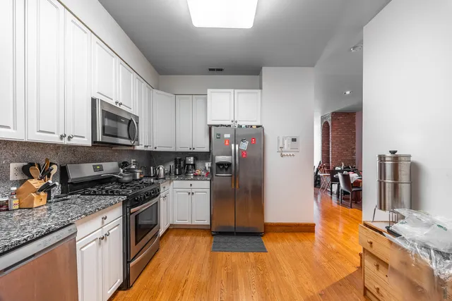 a kitchen with stainless steel appliances granite countertop a refrigerator stove and sink