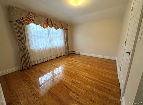 a view of a room with wooden floor entryway and a window