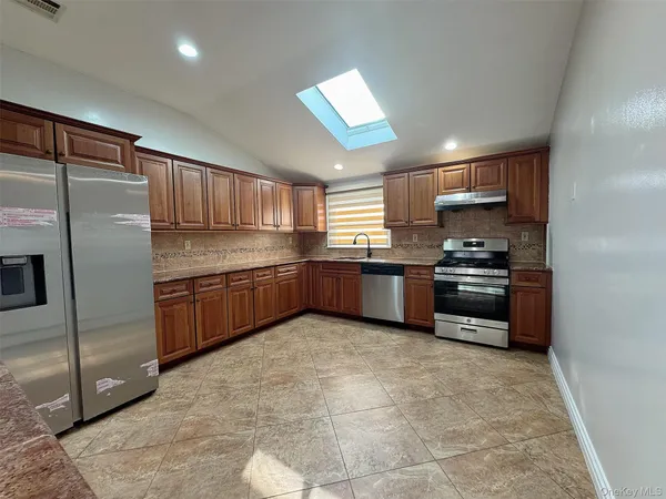 a kitchen with stainless steel appliances granite countertop a refrigerator sink and cabinets