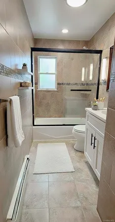 a bathroom with a sink a toilet and mirror