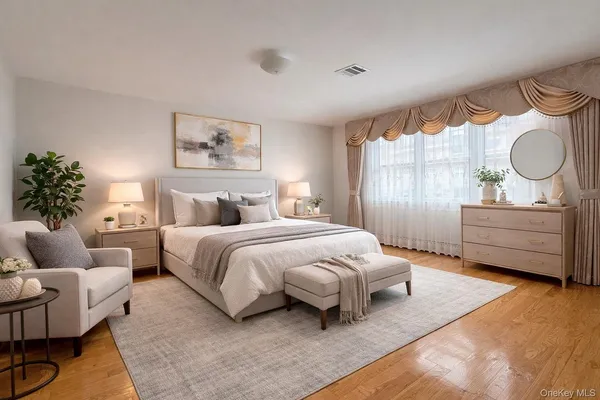 a bedroom with a bed mirror and window