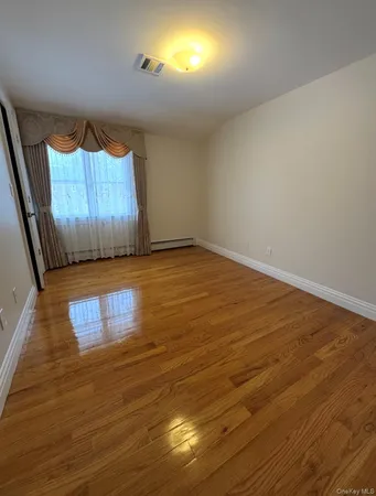 a view of room with wooden floor and windows
