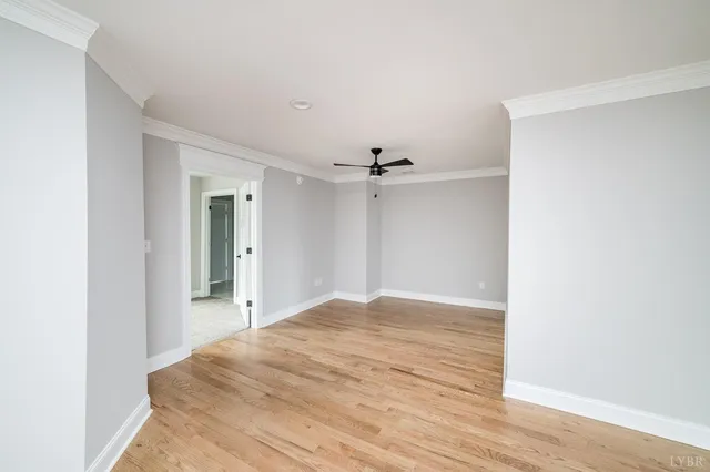 a view of a livingroom with a ceiling fan and wooden floor