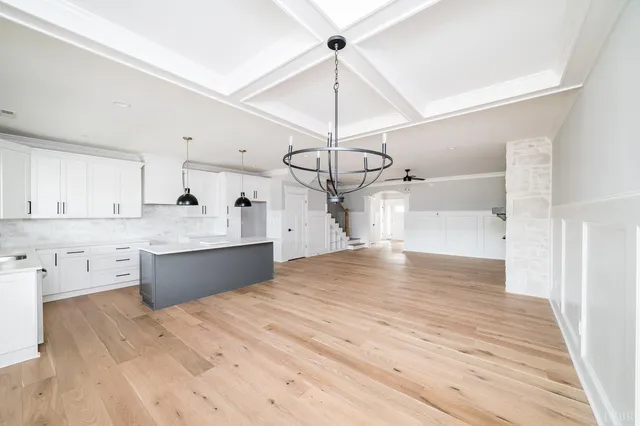 a kitchen with a sink window and cabinets