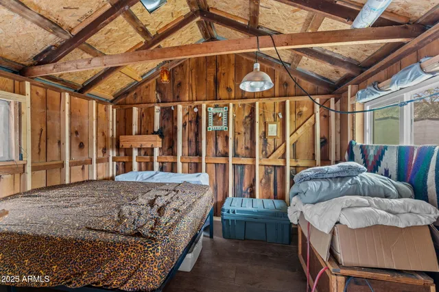 a bed room with a bed and a chair