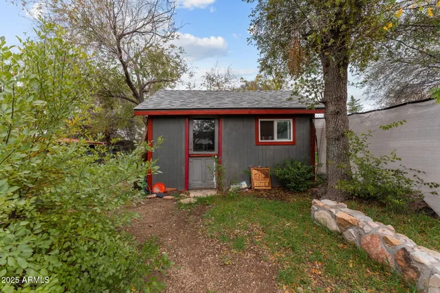 a view of backyard of house with green space