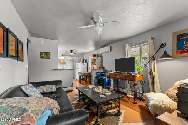 a bedroom with furniture and a flat screen tv