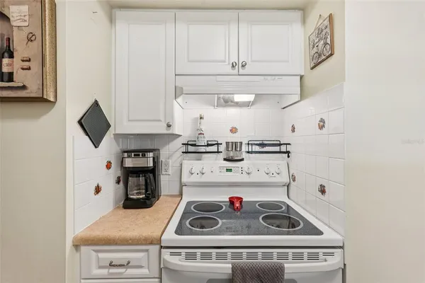 a kitchen with stainless steel appliances granite countertop a refrigerator and a stove