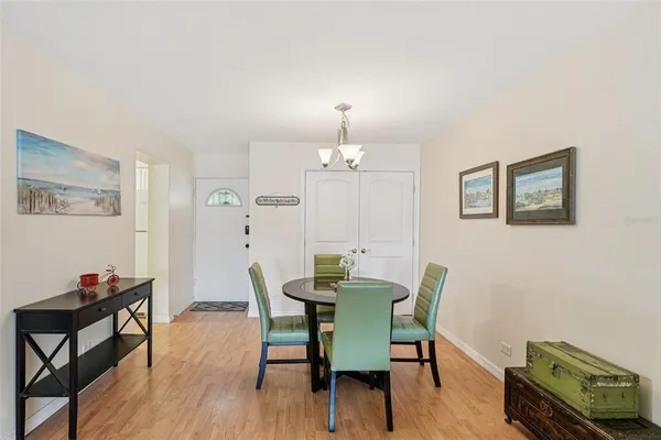 a view of a dining room with furniture wooden floor and chandelier