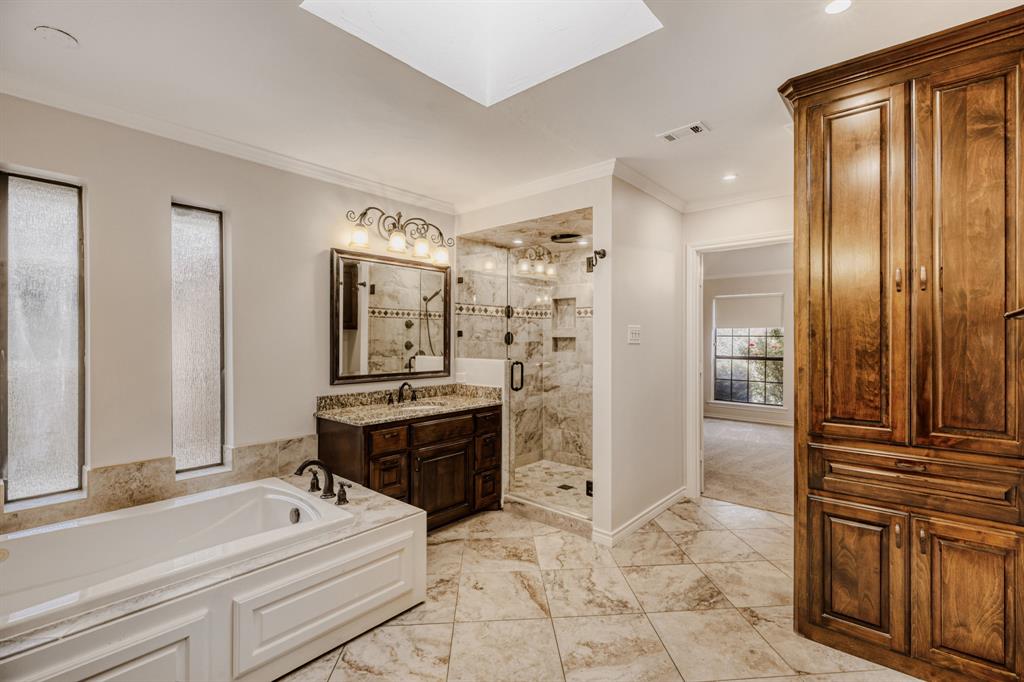 6108 Bluff Point Drive Dallas, TX 75248 - Photo 13 of 28 a bathroom with a tub sink shower and mirror