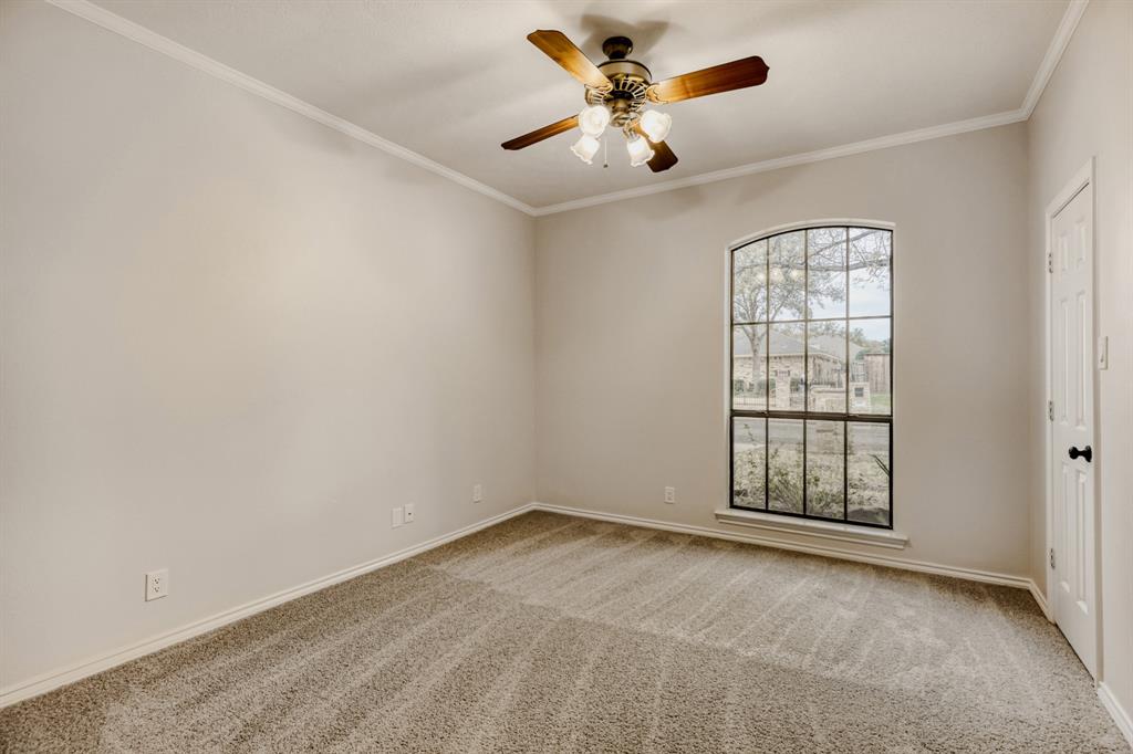 6108 Bluff Point Drive Dallas, TX 75248 - Photo 16 of 28 an empty room with windows and ceiling fan