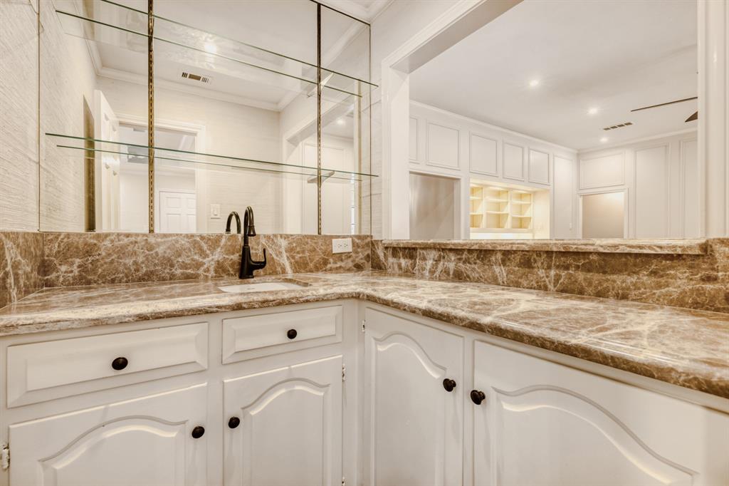 6108 Bluff Point Drive Dallas, TX 75248 - Photo 18 of 28 a sink with granite countertop white cabinets and white appliances
