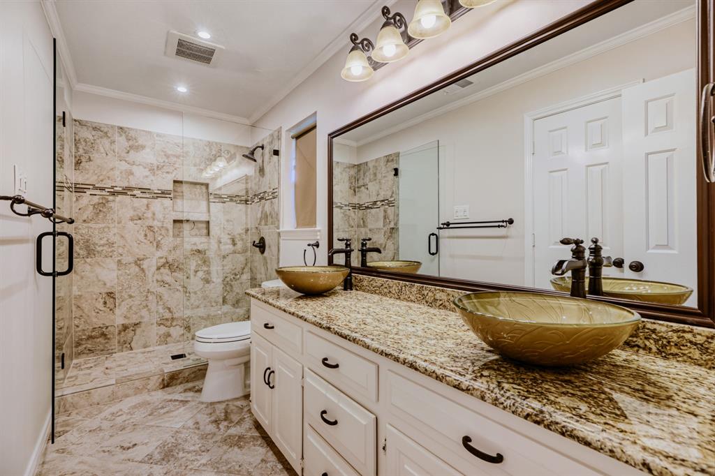 6108 Bluff Point Drive Dallas, TX 75248 - Photo 19 of 28 a spacious bathroom with a granite countertop sink a mirror a bathtub and shower