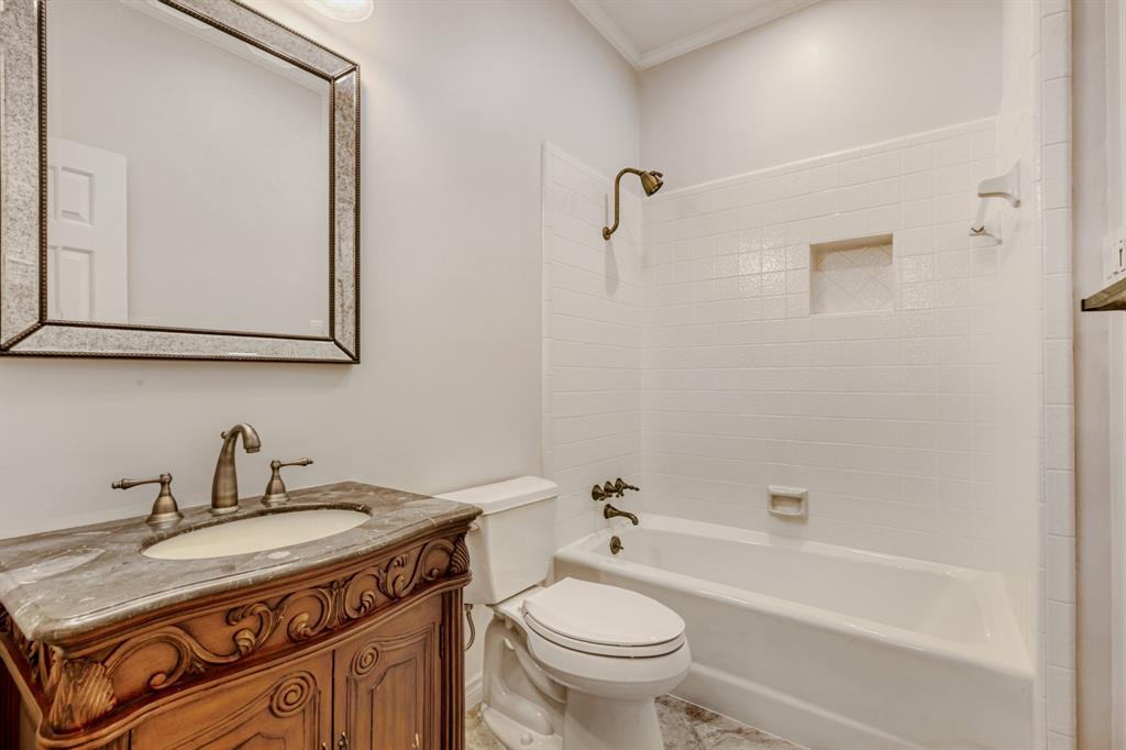 6108 Bluff Point Drive Dallas, TX 75248 - Photo 20 of 28 a bathroom with a granite countertop sink toilet and shower