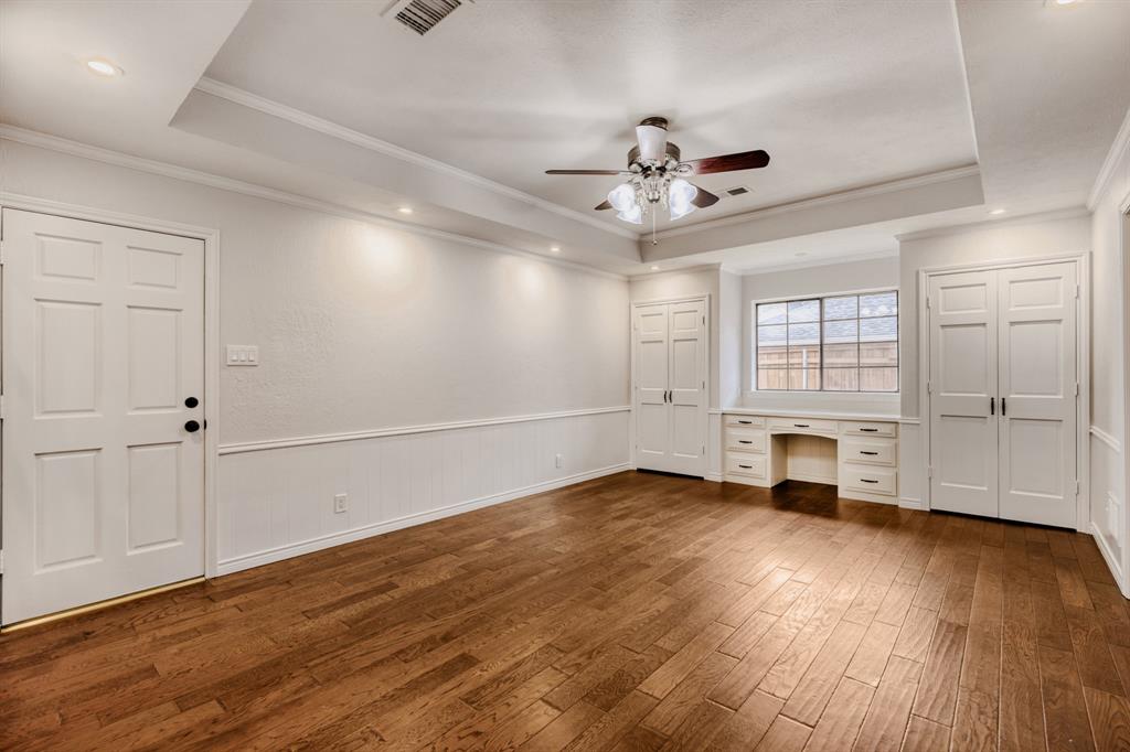 6108 Bluff Point Drive Dallas, TX 75248 - Photo 22 of 28 a view of an empty room with wooden floor and a window