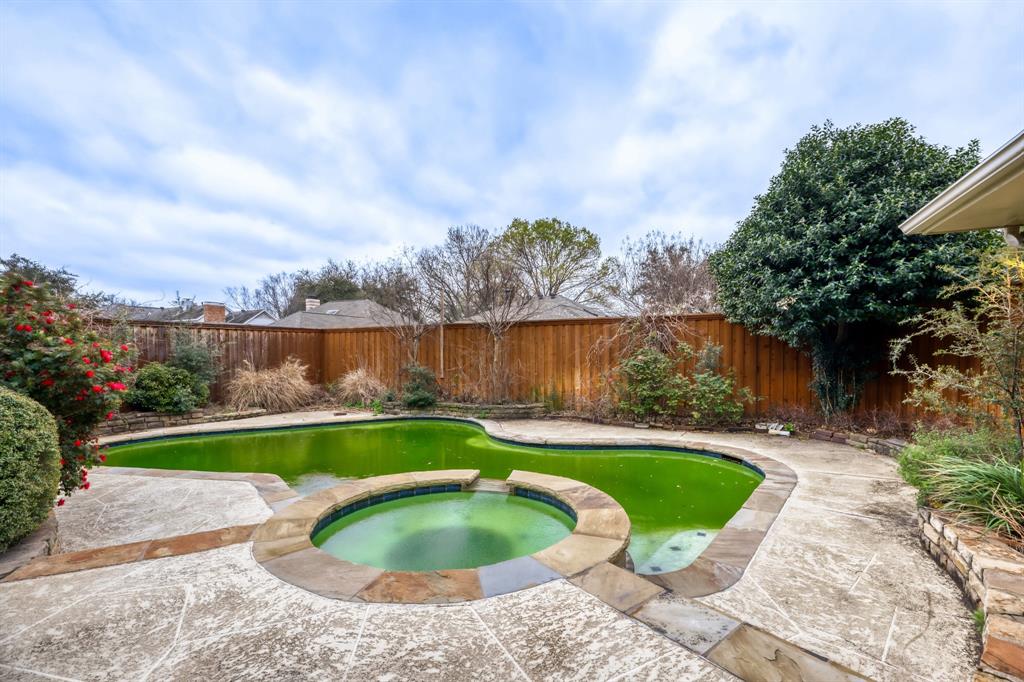 6108 Bluff Point Drive Dallas, TX 75248 - Photo 27 of 28 a view of a swimming pool with a yard and wooden fence