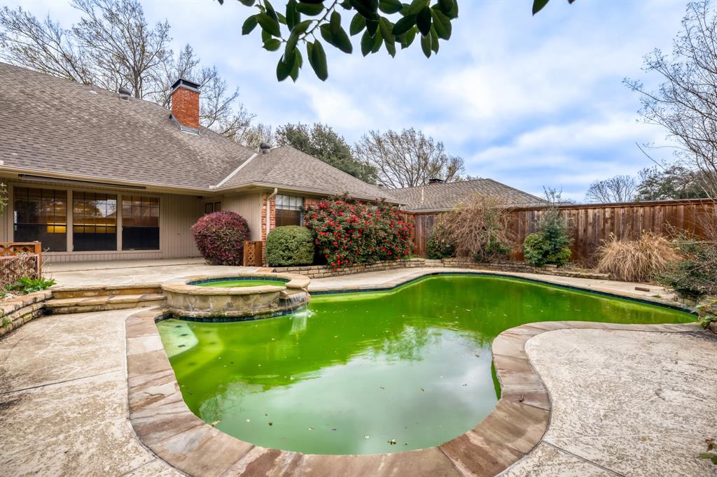 6108 Bluff Point Drive Dallas, TX 75248 - Photo 28 of 28 a view of a swimming pool with a garden