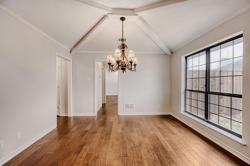 6108 Bluff Point Drive Dallas, TX 75248 - Photo 6 of 28 a view of a room with wooden floor chandelier and windows