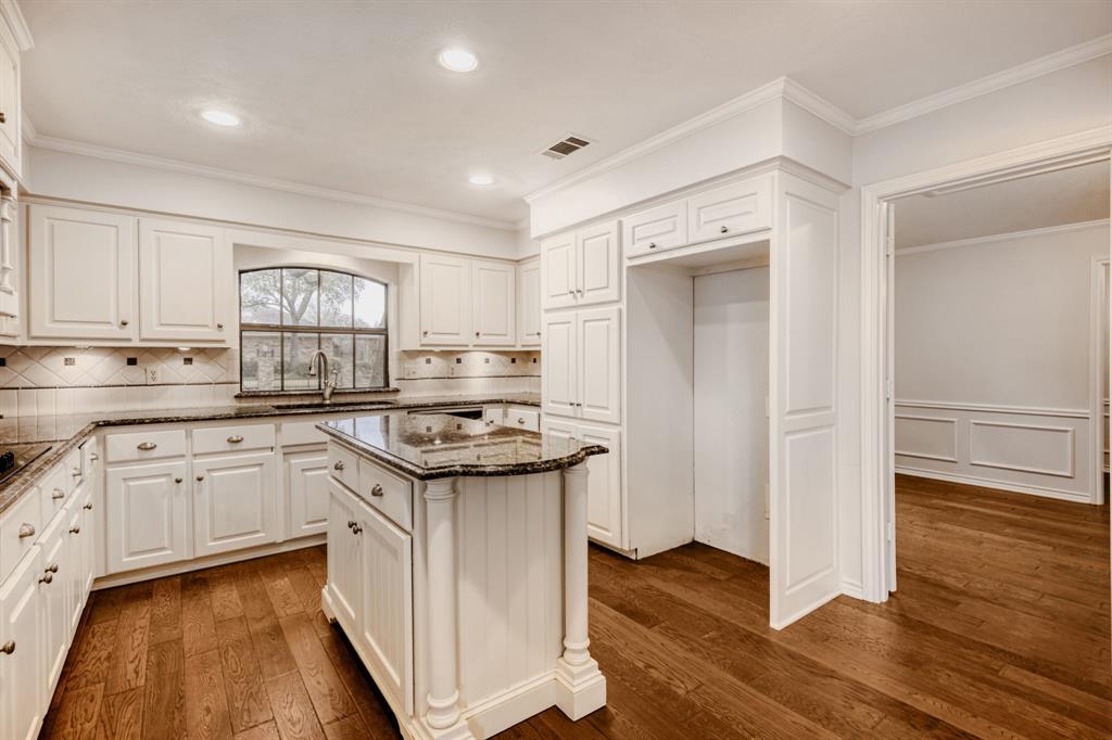 6108 Bluff Point Drive Dallas, TX 75248 - Photo 8 of 28 a kitchen with stainless steel appliances granite countertop cabinets and wooden floor