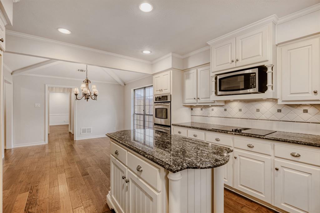 6108 Bluff Point Drive Dallas, TX 75248 - Photo 9 of 28 a kitchen with stainless steel appliances granite countertop a sink and microwave