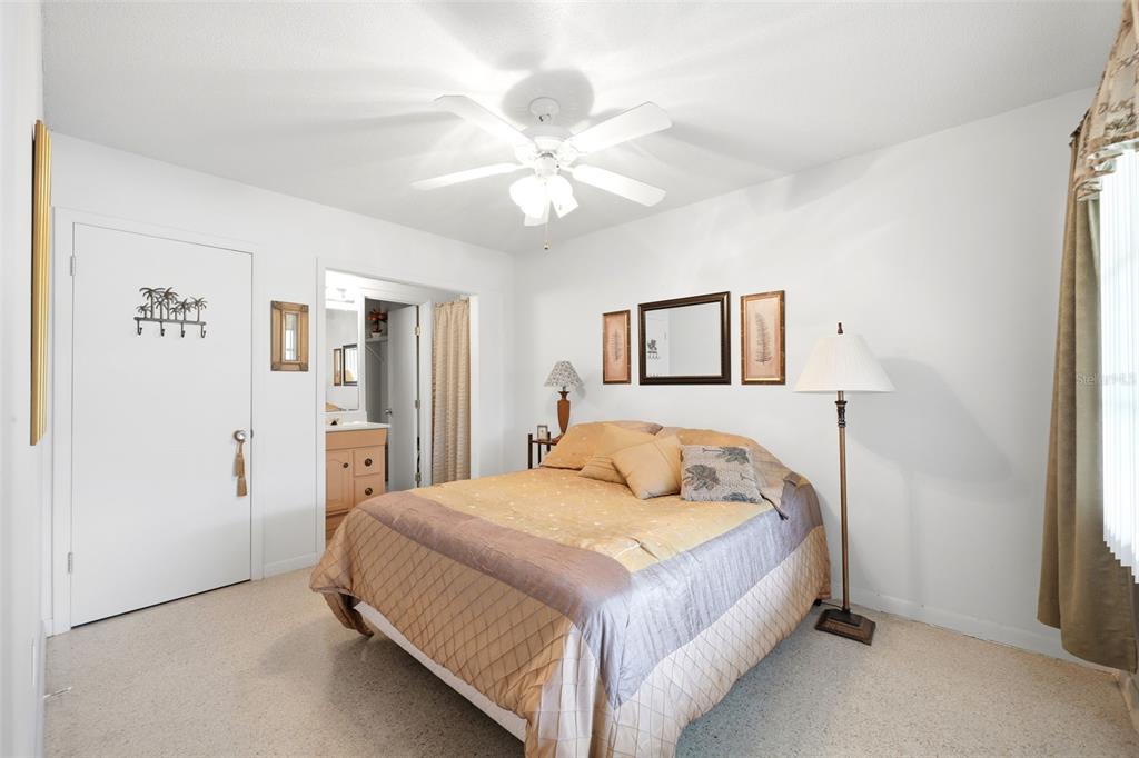 1830 South Mandarin Terrace Inverness, FL 34450 - Photo 14 of 47 a bedroom with a bed and a chandelier
