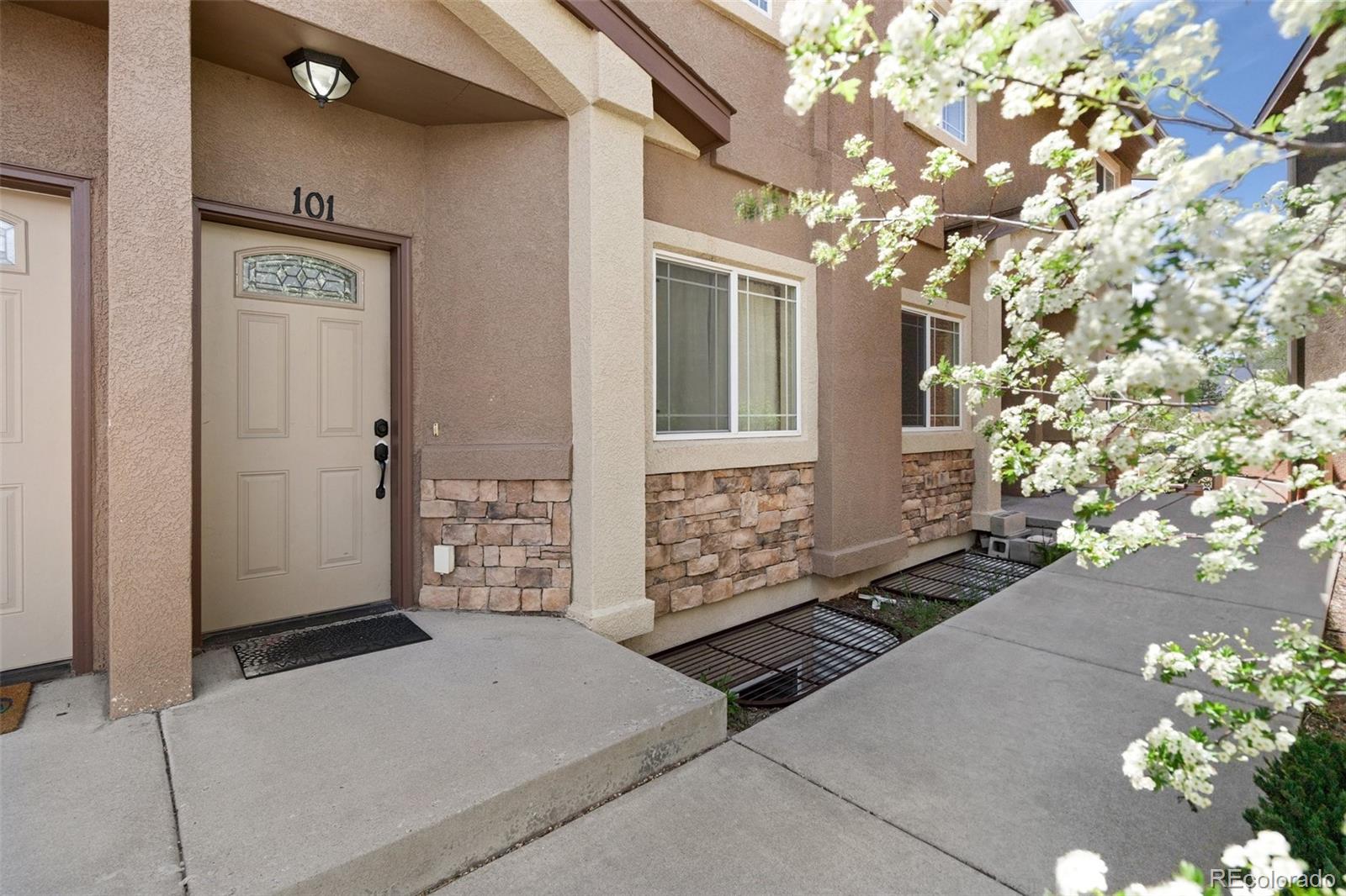 1510 York Road, Unit 101 Colorado Springs, CO 80918 - Photo 1 of 12 a view of a brick house with a tree