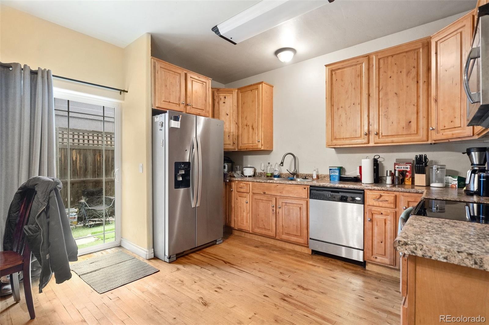 1510 York Road, Unit 101 Colorado Springs, CO 80918 - Photo 5 of 12 a kitchen with granite countertop a refrigerator stove top oven and sink