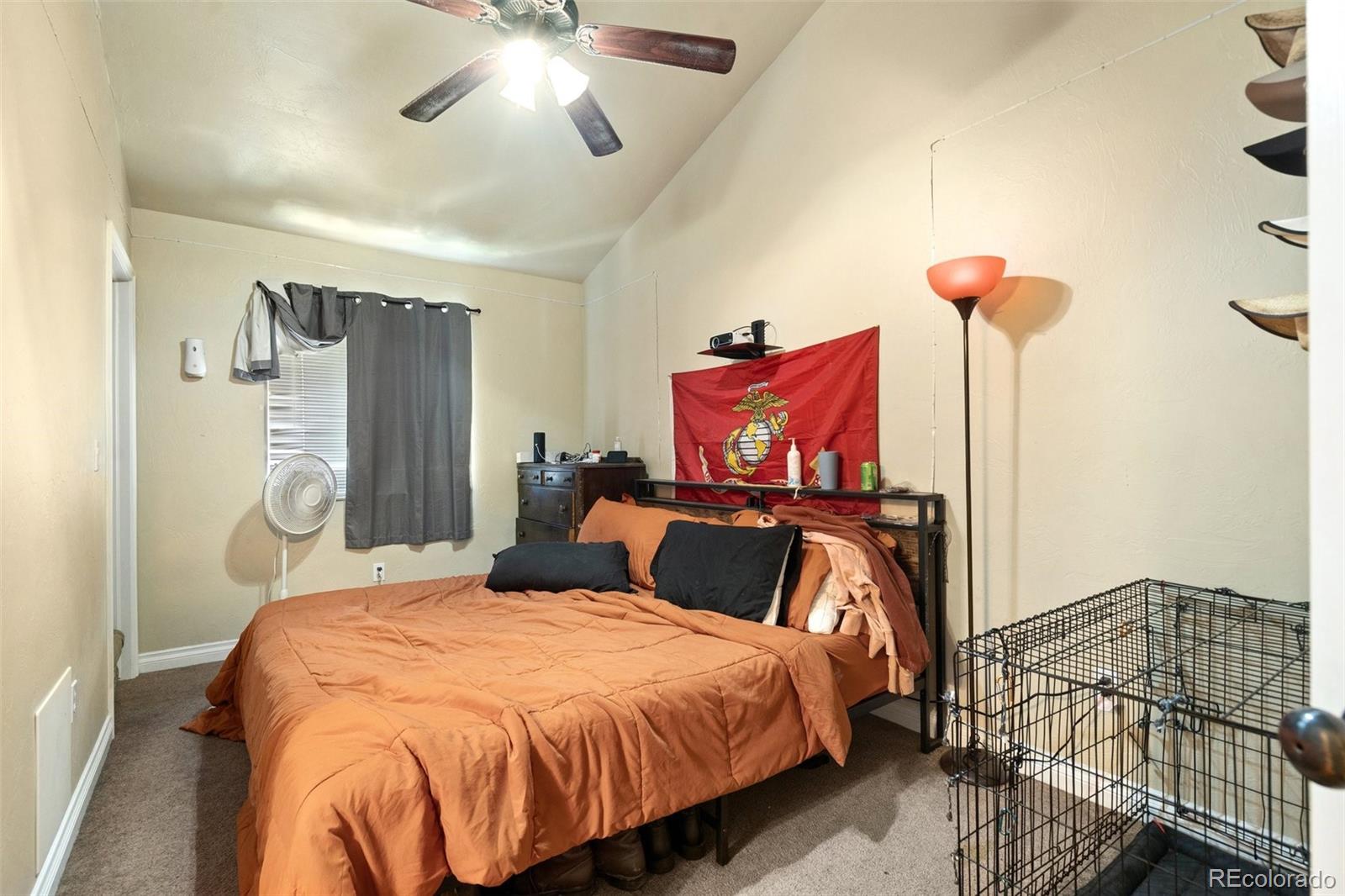 1510 York Road, Unit 101 Colorado Springs, CO 80918 - Photo 10 of 12 a bedroom with bed and a chandelier