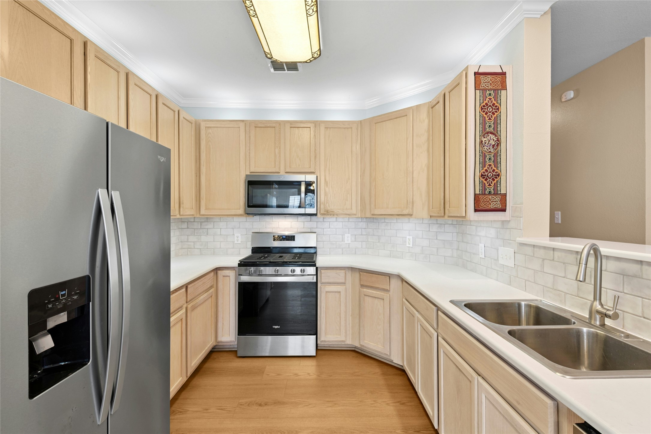 7500 Shadowridge Run, Unit 34 Austin, TX 78749 - Photo 5 of 27 a kitchen with stainless steel appliances granite countertop a refrigerator sink and stove