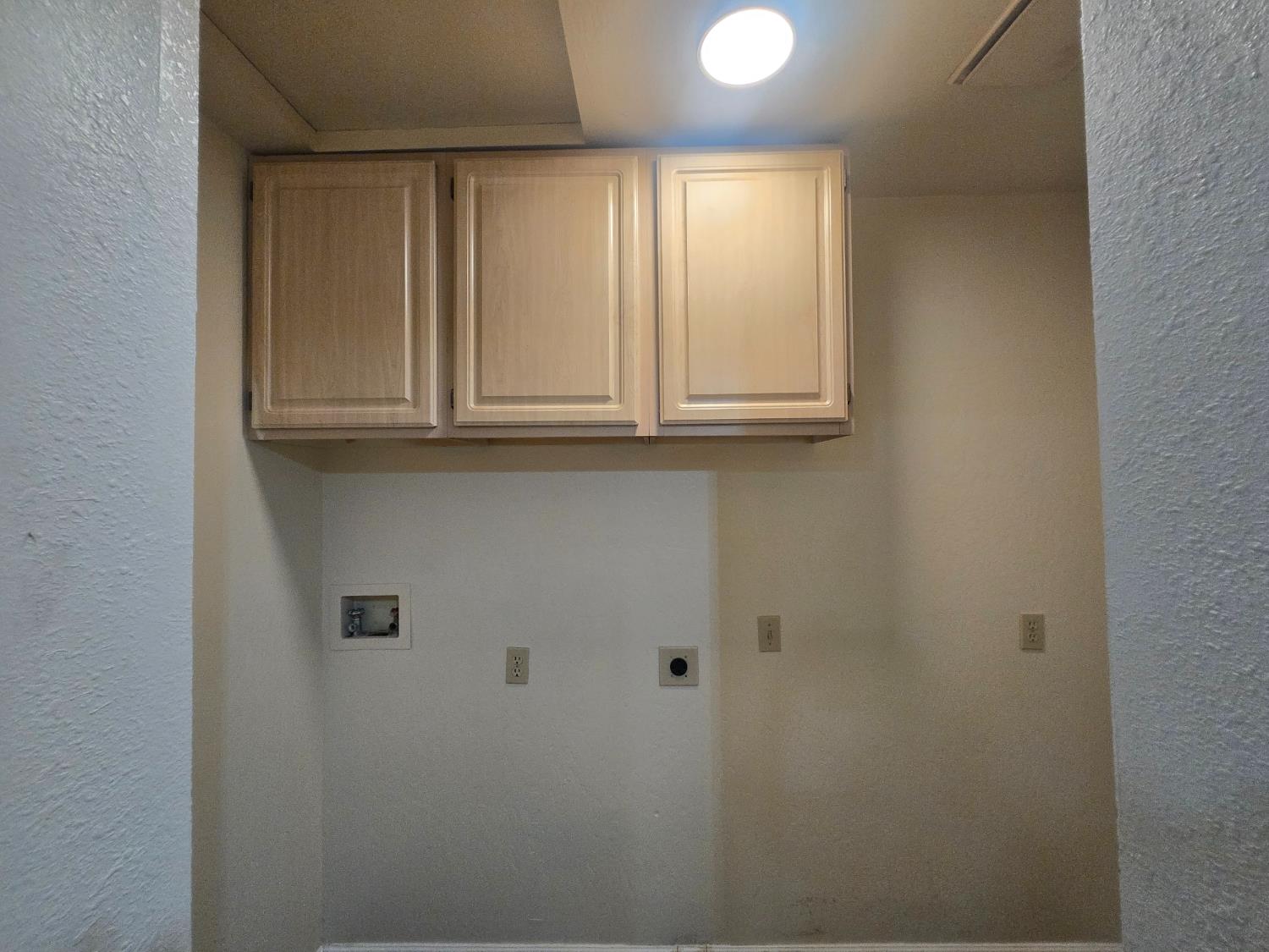 10601 Lime Kiln Road Grass Valley, CA 95949 - Photo 20 of 79 Overhead cabinets in the laundry area.