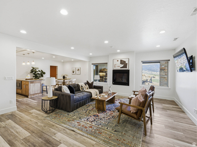 402 Shadow Hill Road Wanship, UT 84017 - Photo 41 of 90 Living area featuring light wood-style floors, recessed lighting, and a glass covered fireplace