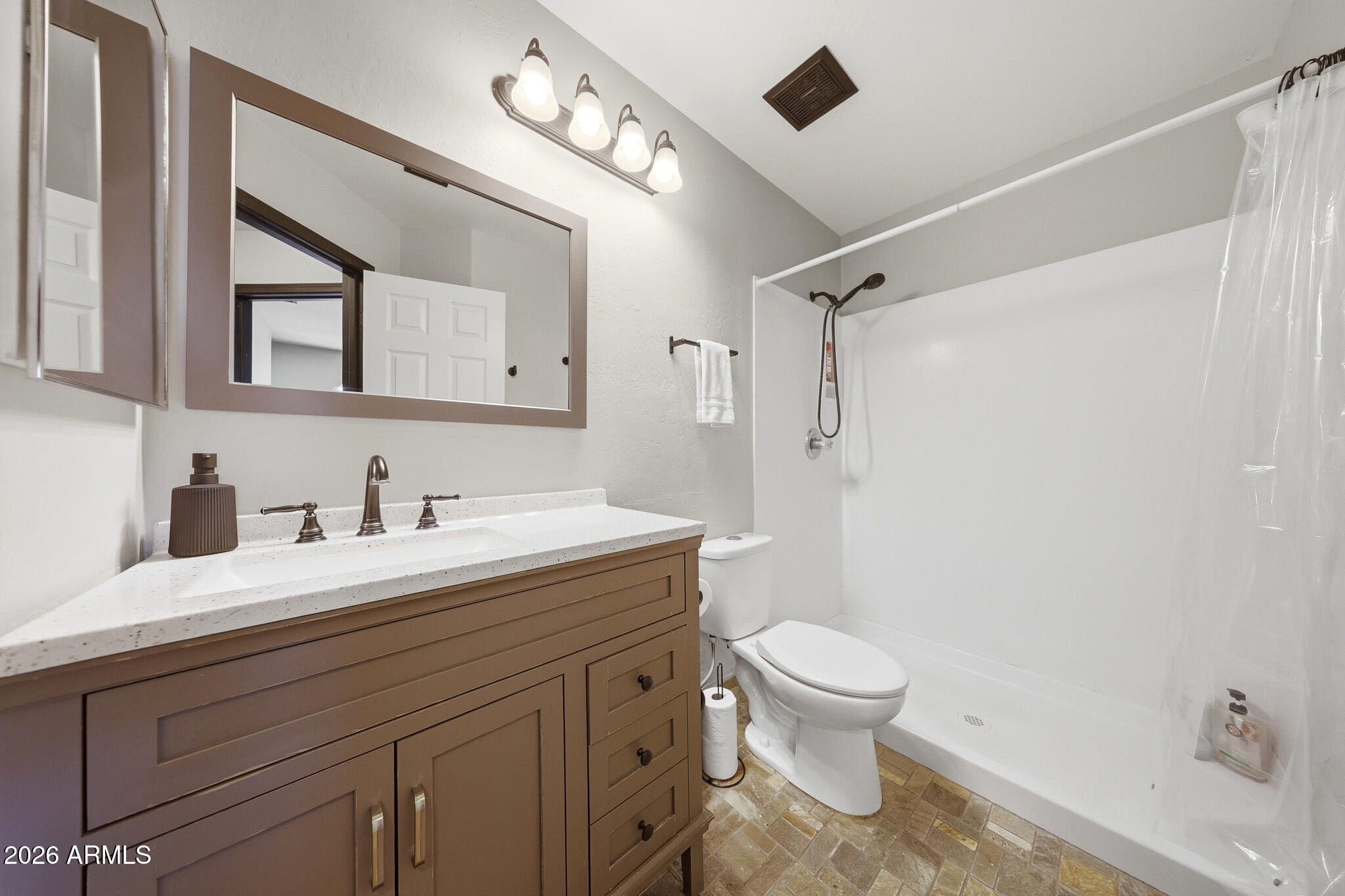 2167 East Nighthawk Way Phoenix, AZ 85048 - Photo 27 of 28 a bathroom with a granite countertop sink a toilet and a mirror