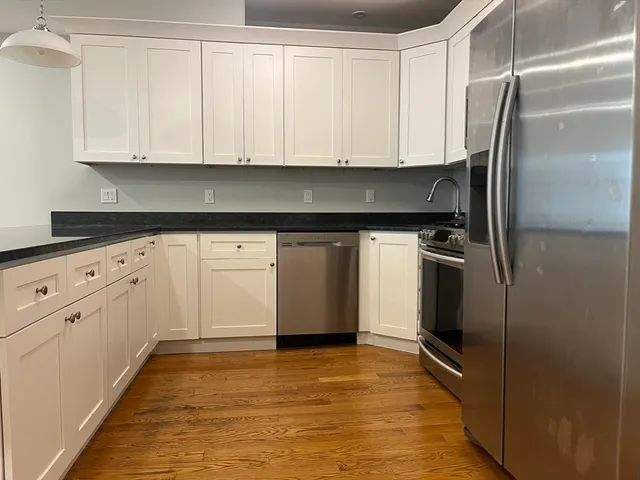a kitchen with stainless steel appliances a refrigerator sink and microwave