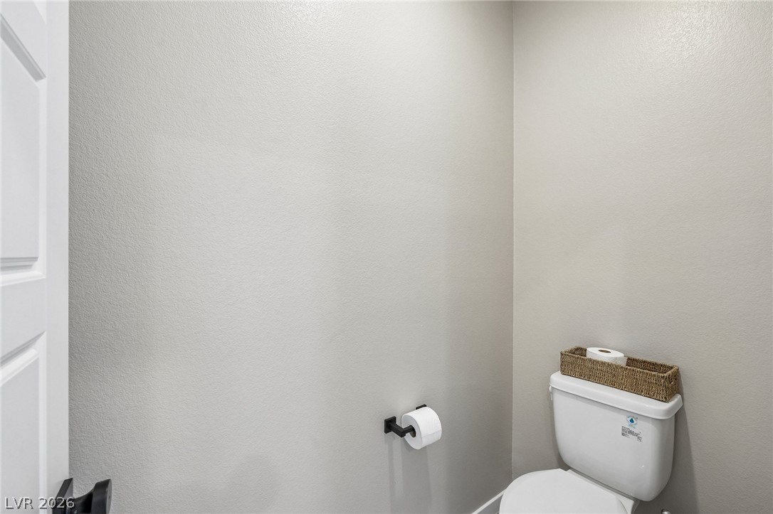 194 Viento Ridge Street Henderson, NV 89012 - Photo 37 of 72 A private water closet showcases clean lines and smooth neutral walls.