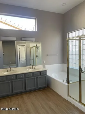 a bathroom with a tub sink and mirror