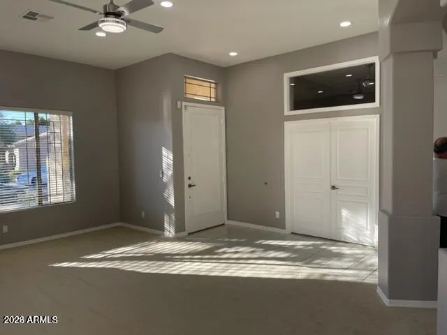 a view of an empty room with window and cabinet