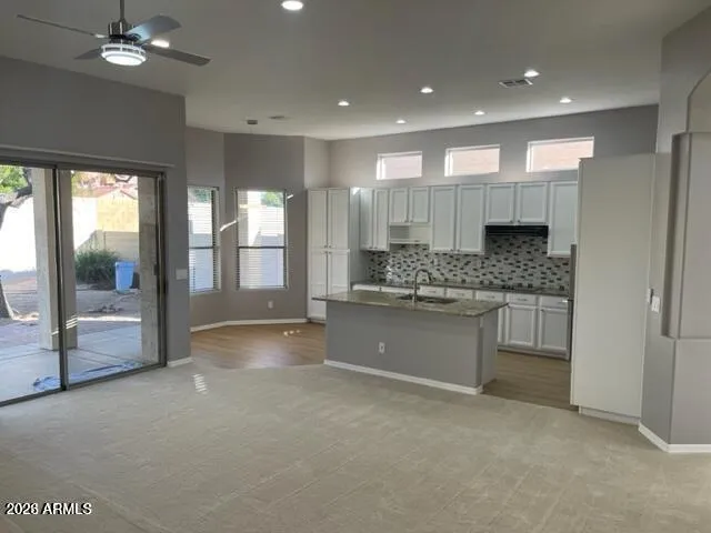a large kitchen with a large window and counter space
