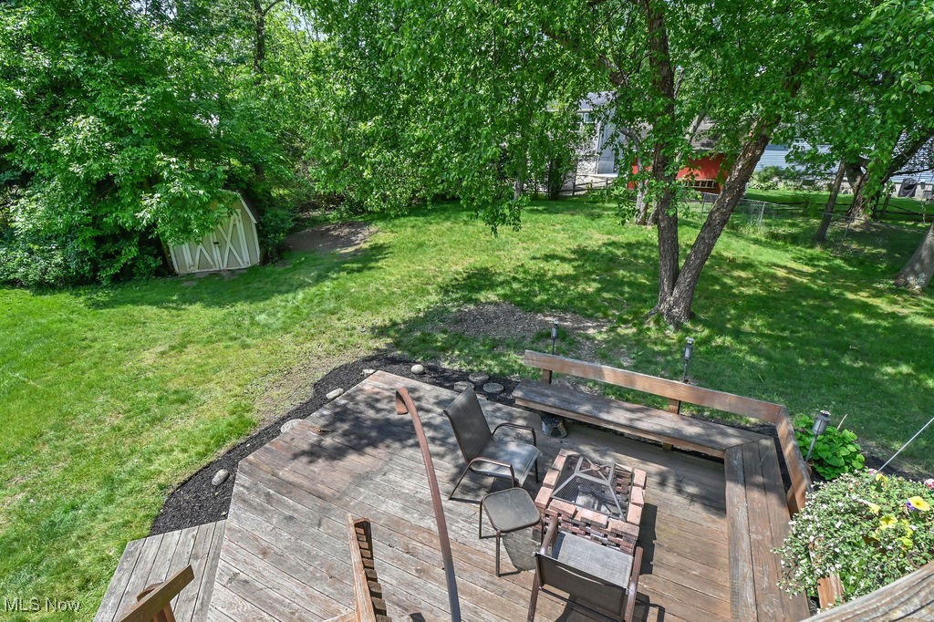 2610 Norton Road Stow, OH 44224 - Photo 7 of 41 View from upper deck, green lawn featuring a lower deck, fire pit, seating area & storage shed