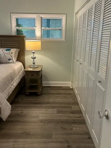 a bedroom with a bed and a lamp on table