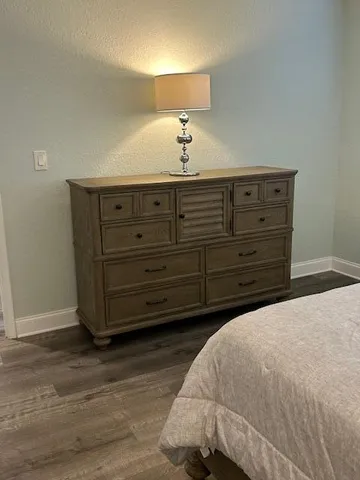 a bedroom with a bed and a dresser
