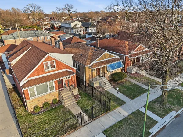 an aerial view of residential houses with outdoor space