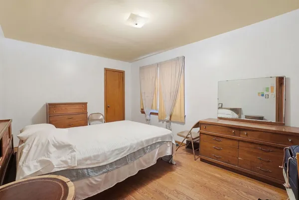 a bedroom with a bed and a dresser