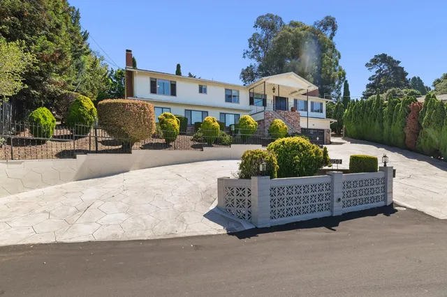 a front view of a house with garden