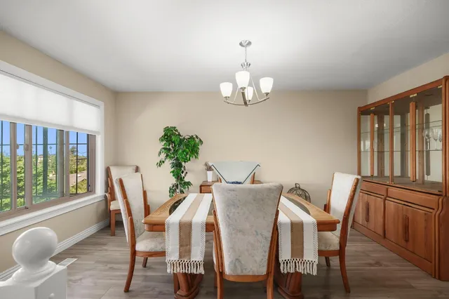 a view of a dining room with furniture wooden floor and chandelier