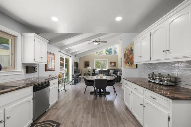 a kitchen with sink cabinets and wooden floor