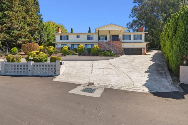 a front view of a house with a yard and a garage