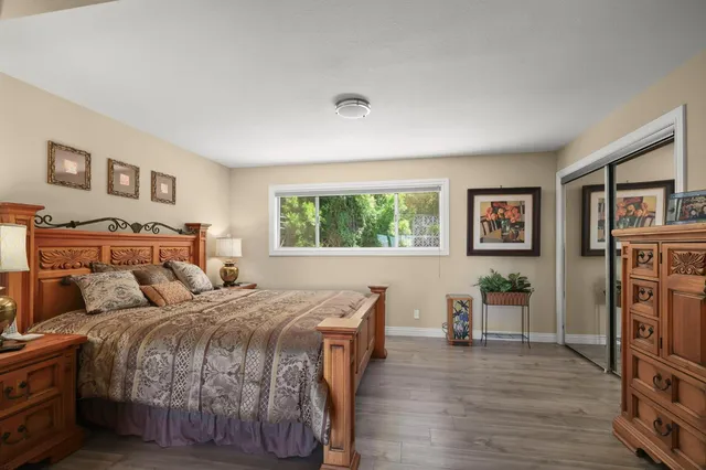 a bedroom with a large bed and a tv